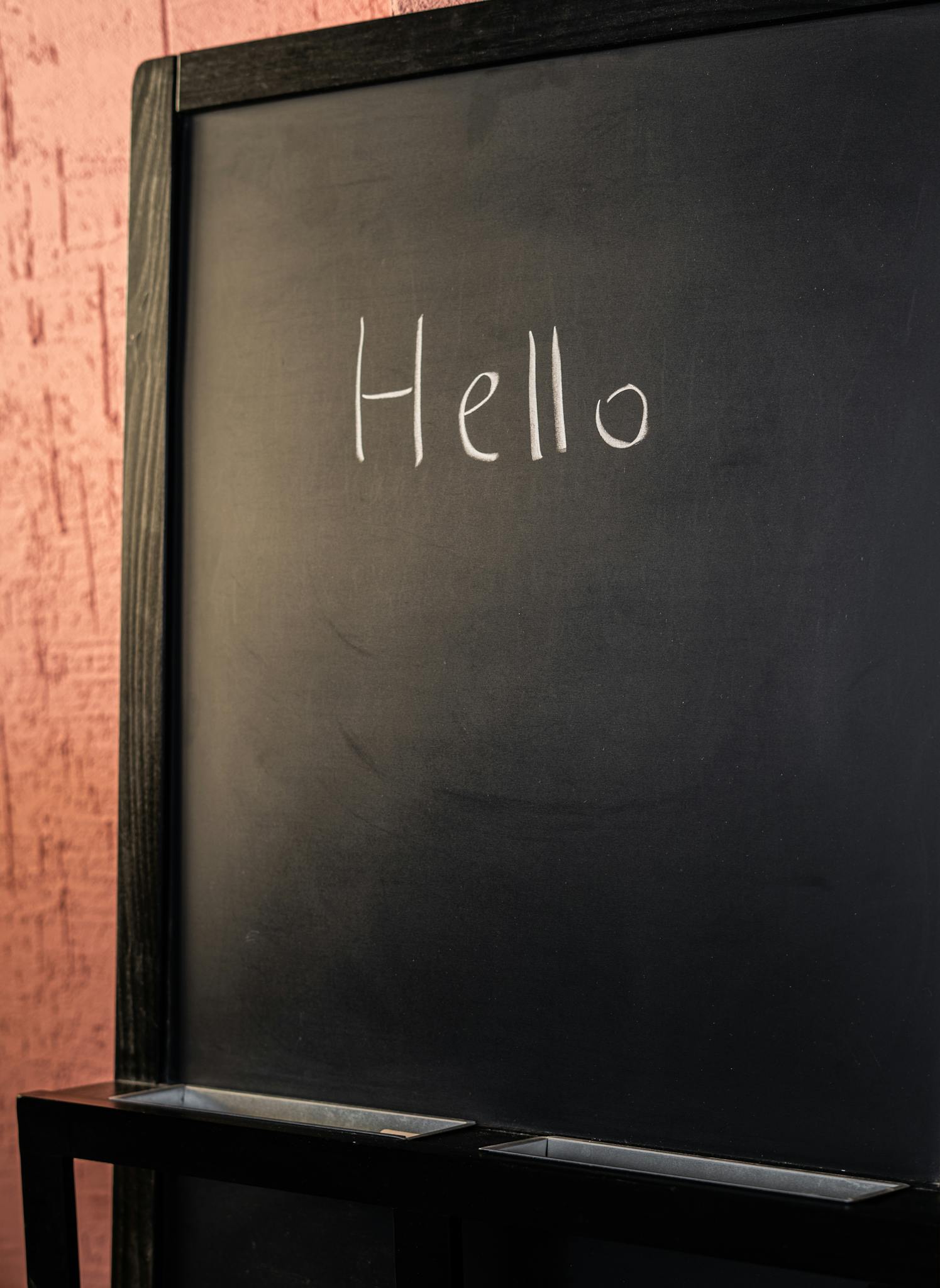 Chalkboard with the word 'Hello' written in chalk, suitable for educational themes.